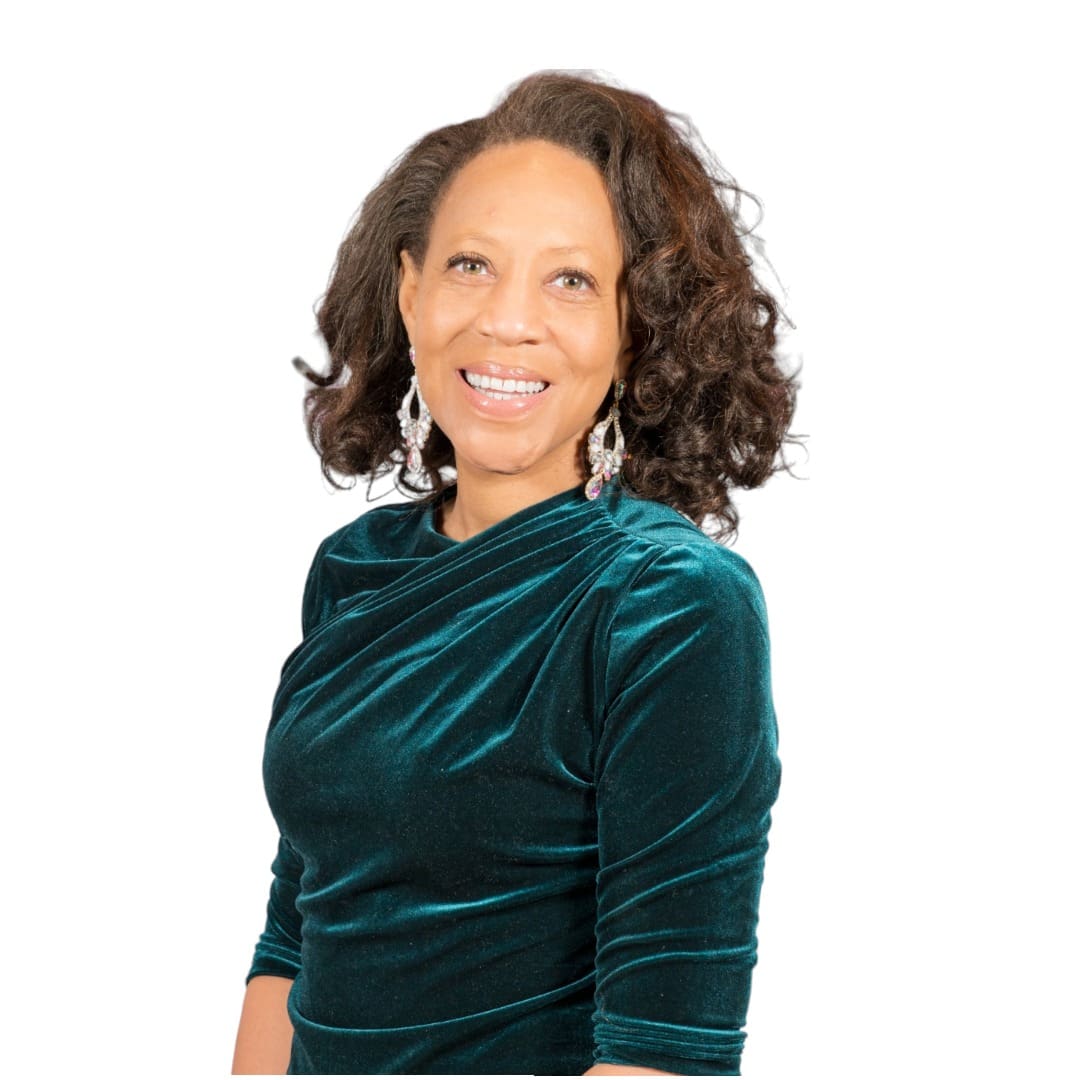 Woman in velvet green dress smiling at camera