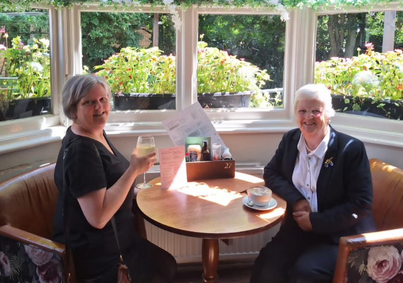 Picture of Grace Jappy's mum and gran sat together at a table in a cafe