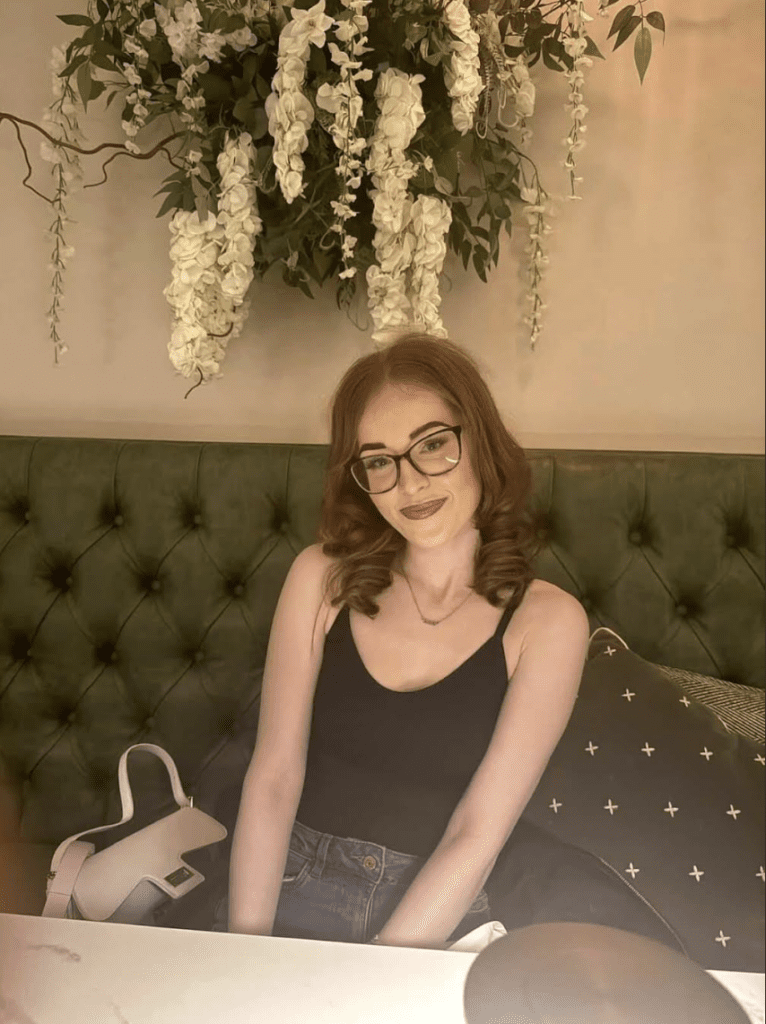 Girl with short hair and tank top smiling for photo
