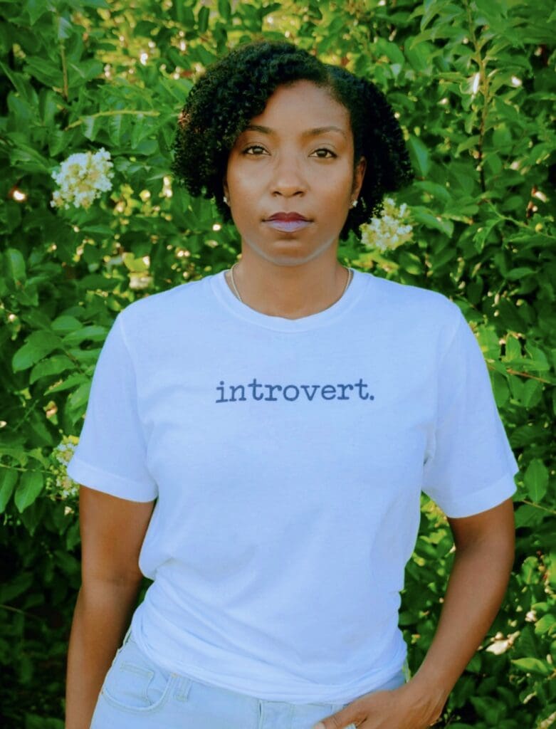 Woman wearing blue shirt that says introvert on it